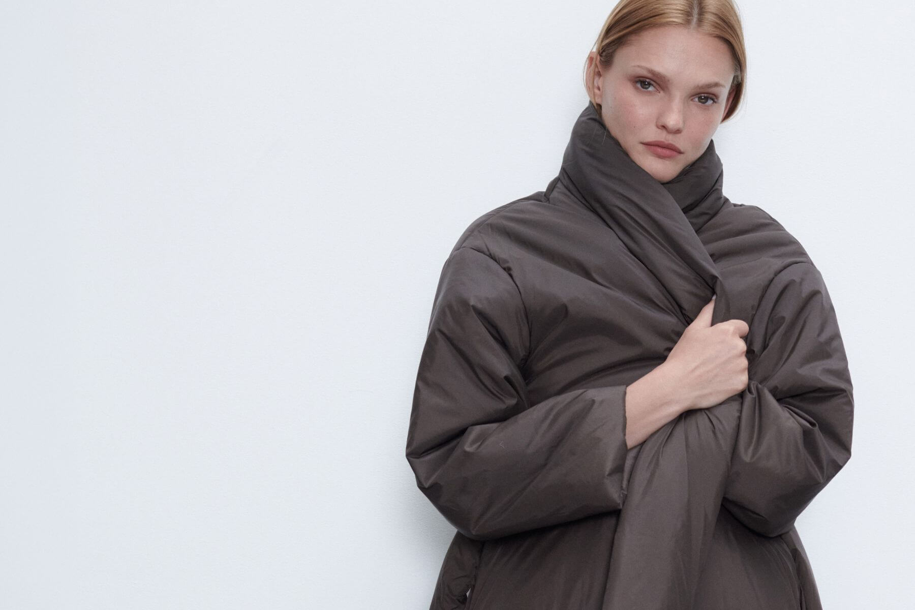 Close up of model in bo puffer jacket in brown.